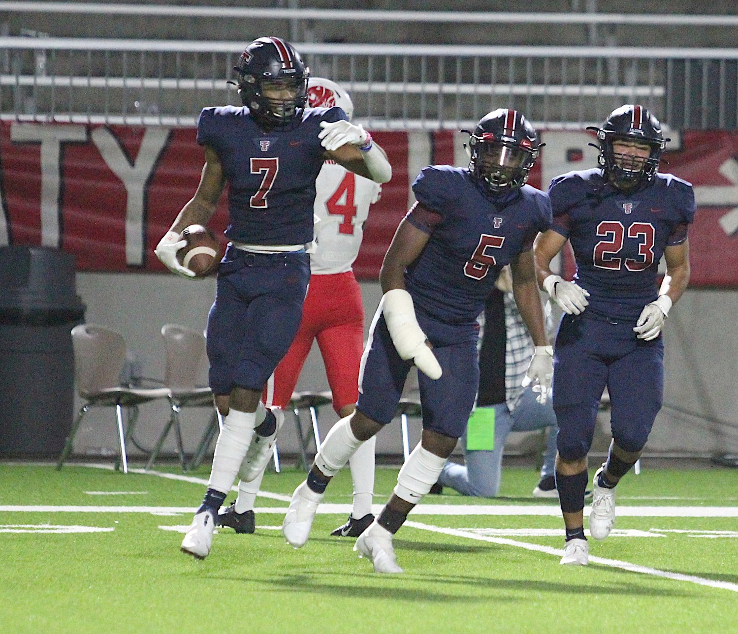 Tompkins senior defensive back Dru Polidore celebrates after his second-half interception during the Falcons' 24-19 win over Katy on Thursday evening at Legacy Stadium.